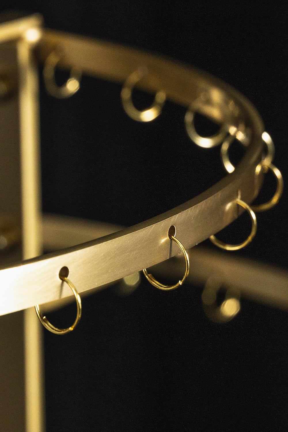 Aurelia Tiered Capiz Table Lamp | Capiz Shell, Metal | Close-up focus on the empty tiered gold brass metal frame showcasing the small hanging ring attachments | Detail shot | Samu Lamp