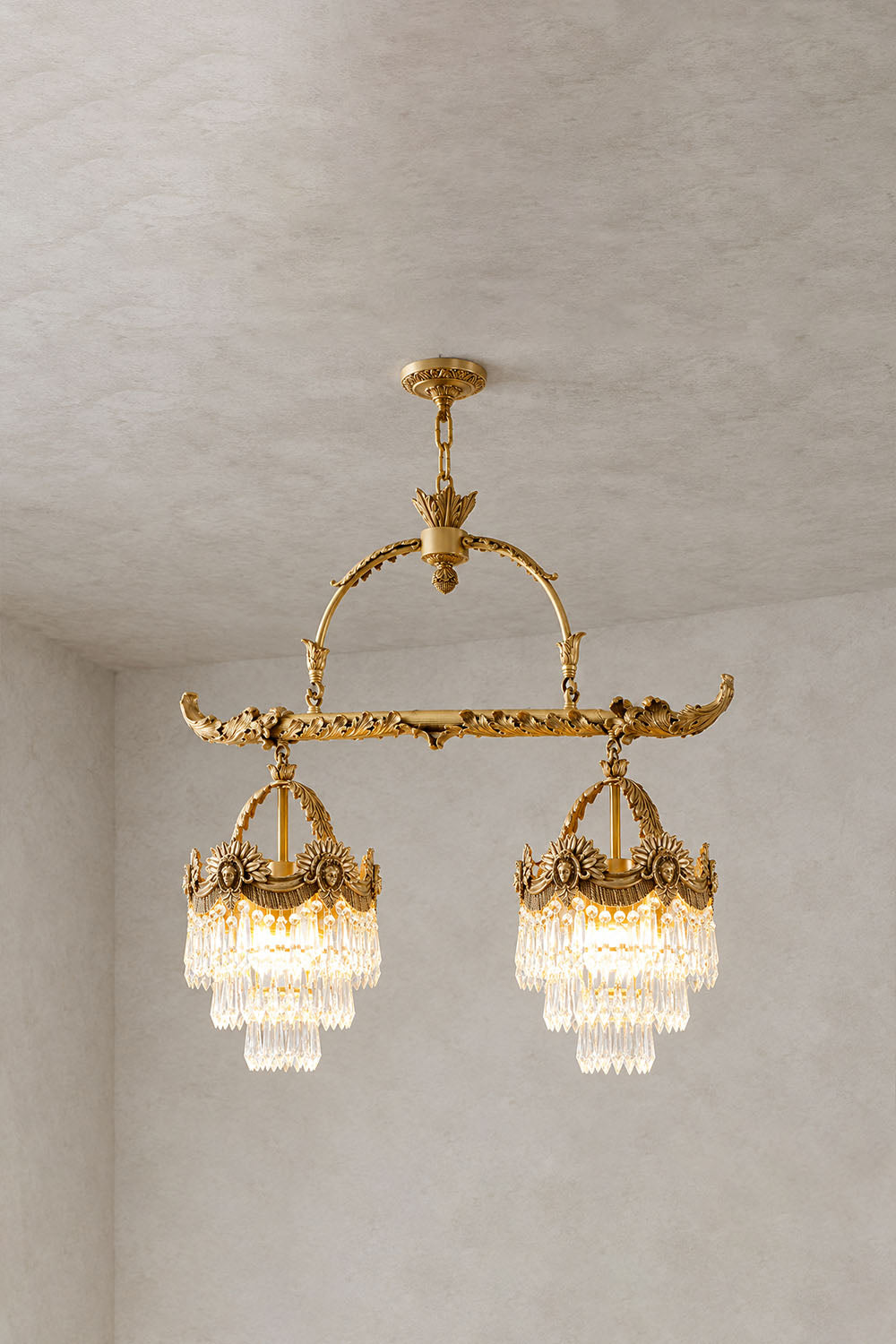 Aurelien Crystal Crown Brass Island Chandelier | Cut Crystal and Brass | 2-light island chandelier variant illuminated on a neutral wall backdrop | Samu Lamp