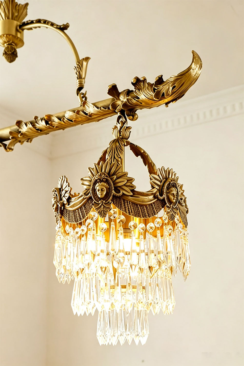 Aurelien Crystal Crown Brass Island Chandelier | Cut Crystal and Brass | Close-up detail showing the glowing crystal shade and ornate brass scrollwork | Samu Lamp