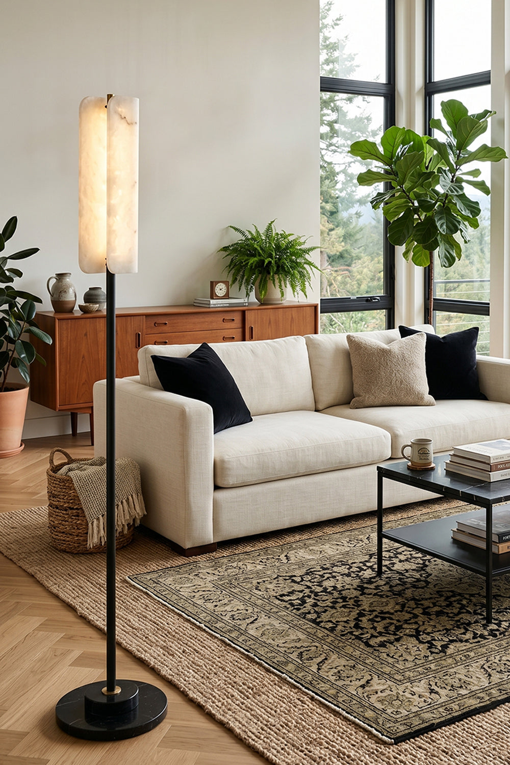 Aurelius Alabaster Brass Floor Lamp | Alabaster, Brass | Positioned gracefully in a contemporary living room next to a cream fabric sofa, low coffee table, and a vintage patterned rug | Samu Lamp