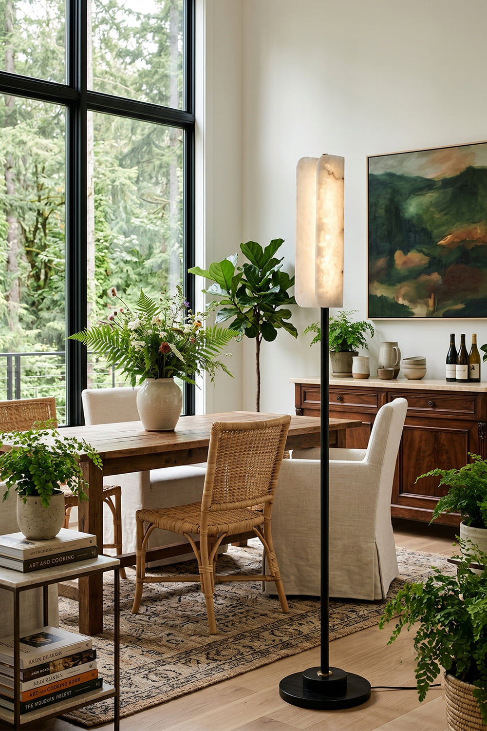 Aurelius Alabaster Brass Floor Lamp | Alabaster, Brass | Staged as an elegant corner light fixture in a bright formal dining room next to a wooden table and woven cane dining chairs | Samu Lamp