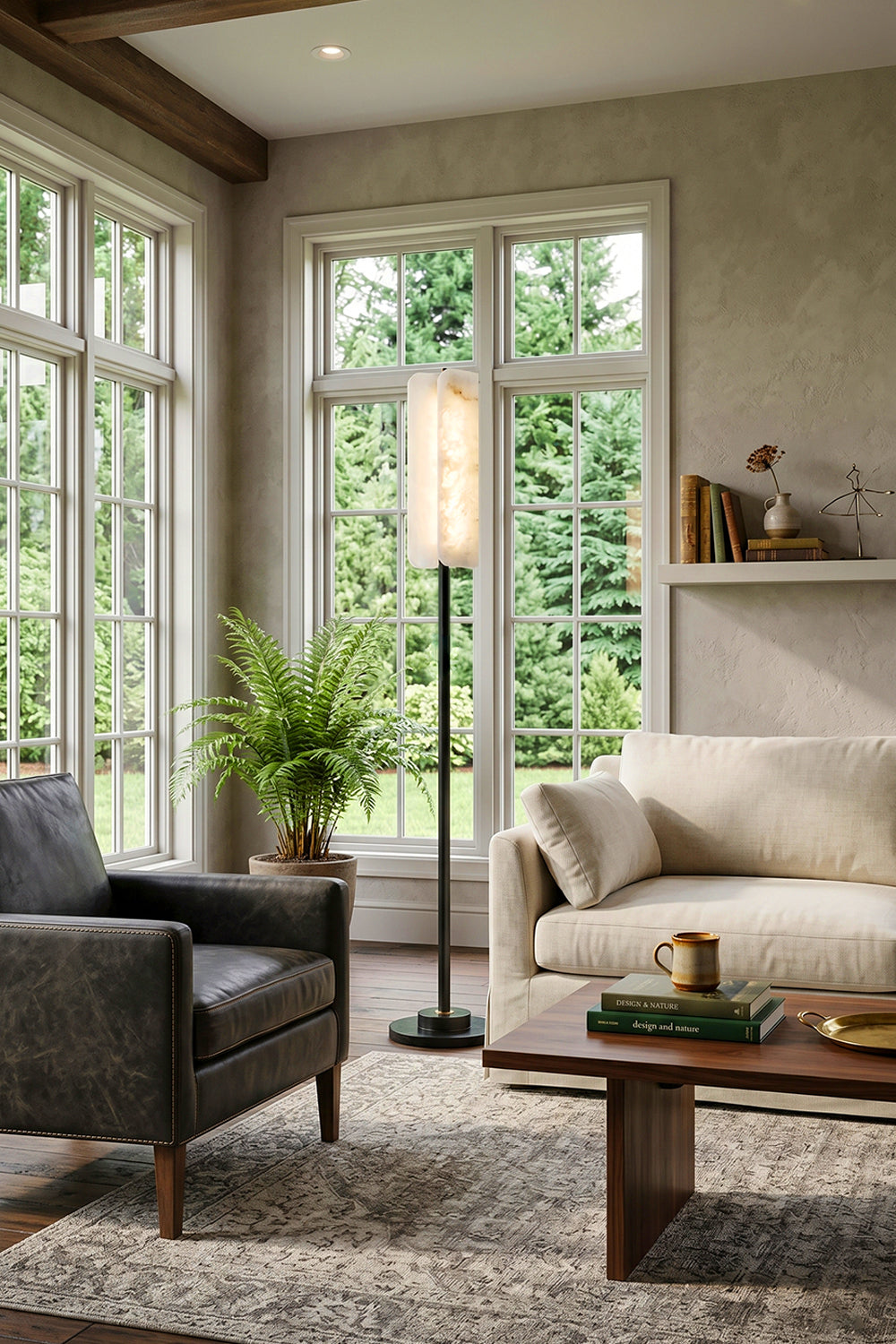 Aurelius Alabaster Brass Floor Lamp | Alabaster, Brass | Placed next to a dark grey upholstered armchair and a cream couch in a spacious sunlit lounge room near large grid windows | Samu Lamp