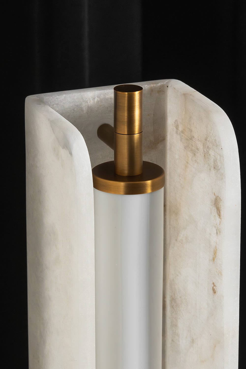 Aurelius Alabaster Brass Floor Lamp | Alabaster, Brass | Close-up top structural shot highlighting the inner frosted glass diffuser tube and brushed brass cap inside the translucent U-shaped alabaster block | Detail shot | Samu Lamp