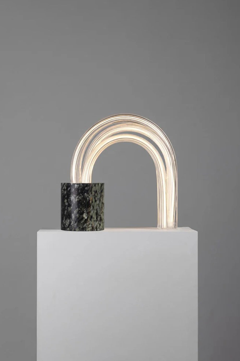 Aurelius Ribbed Marble Table Lamp showcasing architectural design with marble base and glass shade.