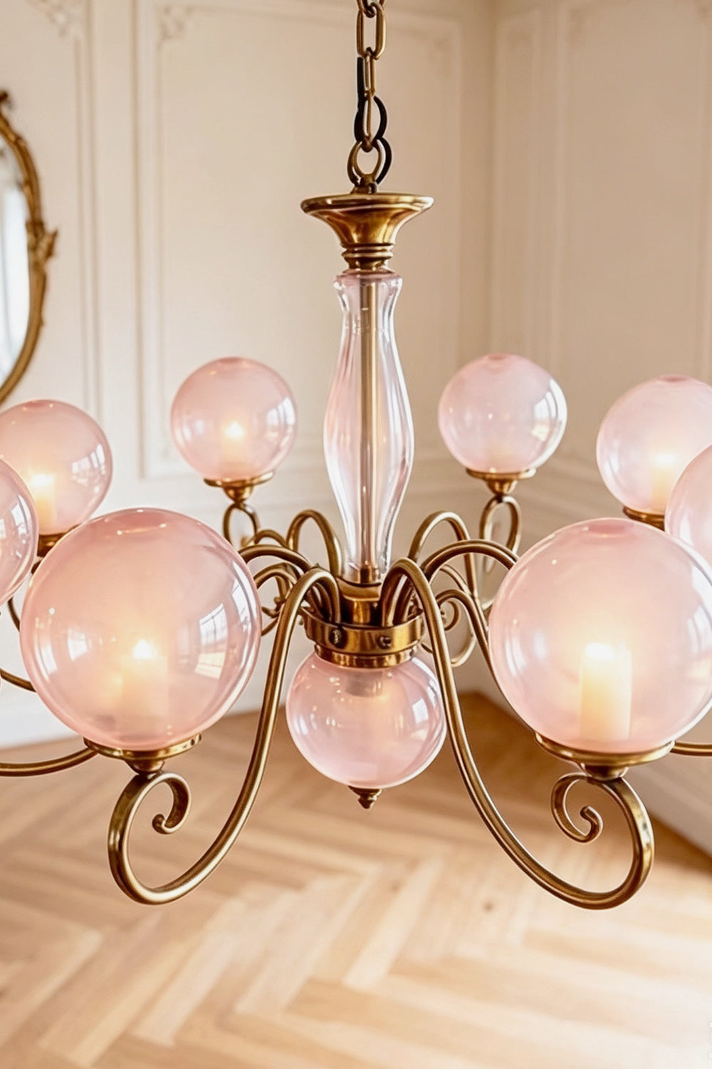 Aveline Globe Cluster Chandelier | Colored Glass and Brass | Medium close-up showing pink glass globes and curved brass scroll arms | Samu Lamp