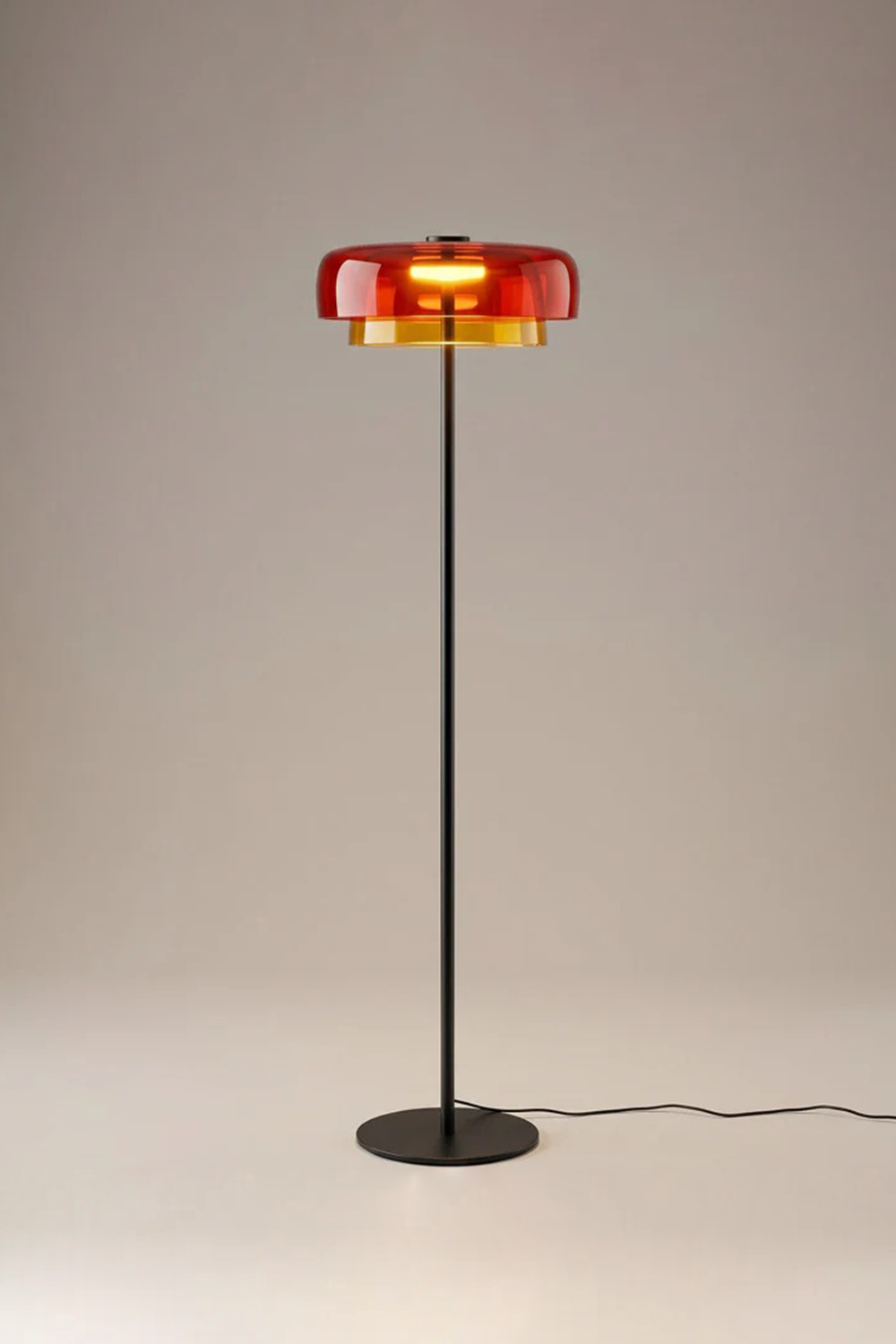 Aven Minimalist Architectural Floor Lamp | Glass, Metal | Studio view of the fully illuminated orange glass variant radiating a cozy sunset hue halo on a neutral studio backdrop | Samu Lamp
