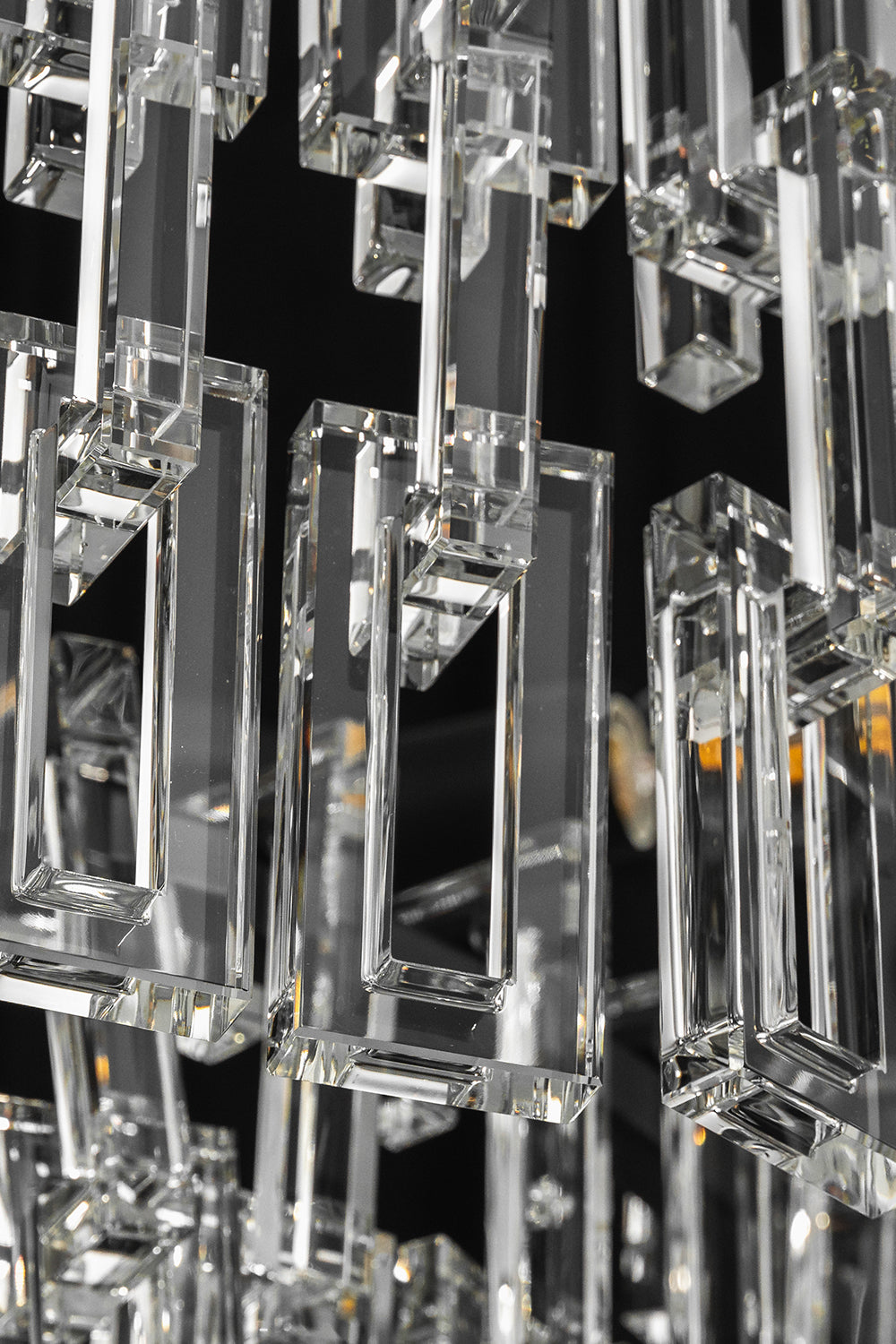 Aven Tiered Glass Prism Chandelier | Glass, Metal | Extreme close-up highlighting the interlocking rectangular clear glass link prisms hooked onto the frame | Detail shot | Samu Lamp