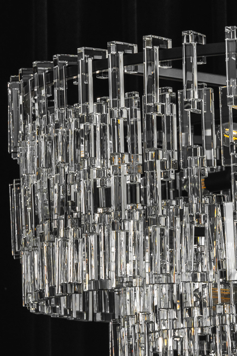 Aven Tiered Glass Prism Chandelier | Glass, Metal | Profile studio close-up of the unlit crystal chandelier highlighting the sparkle of clear glass against a dark background | Samu Lamp