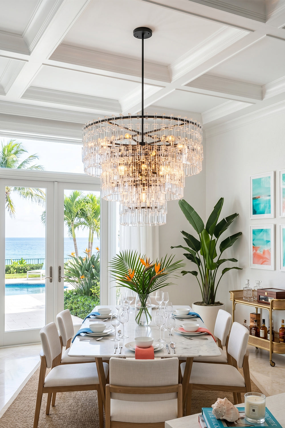 Aven Tiered Glass Prism Chandelier | Glass, Metal | Suspended as a luxurious centerpiece over a wooden table in a bright coastal villa dining room overlooking the ocean | Samu Lamp