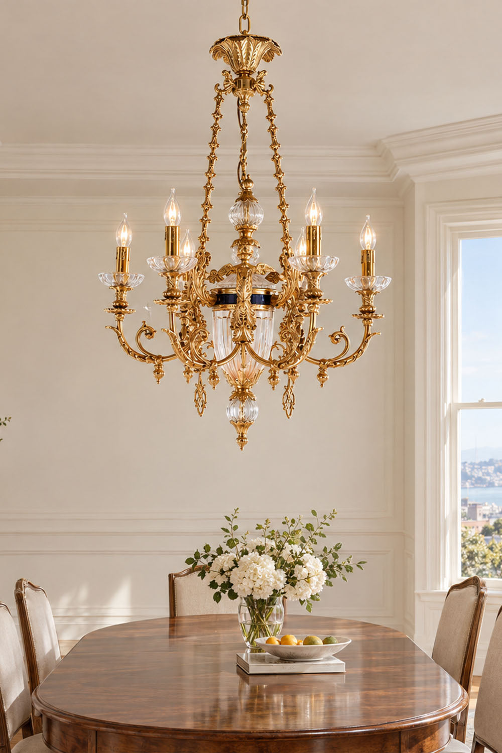 Aveyron Brass Urn Candle Chandelier | Solid Brass and Glass | Lighting a bright dining area above a table with fresh flower arrangements | Samu Lamp
