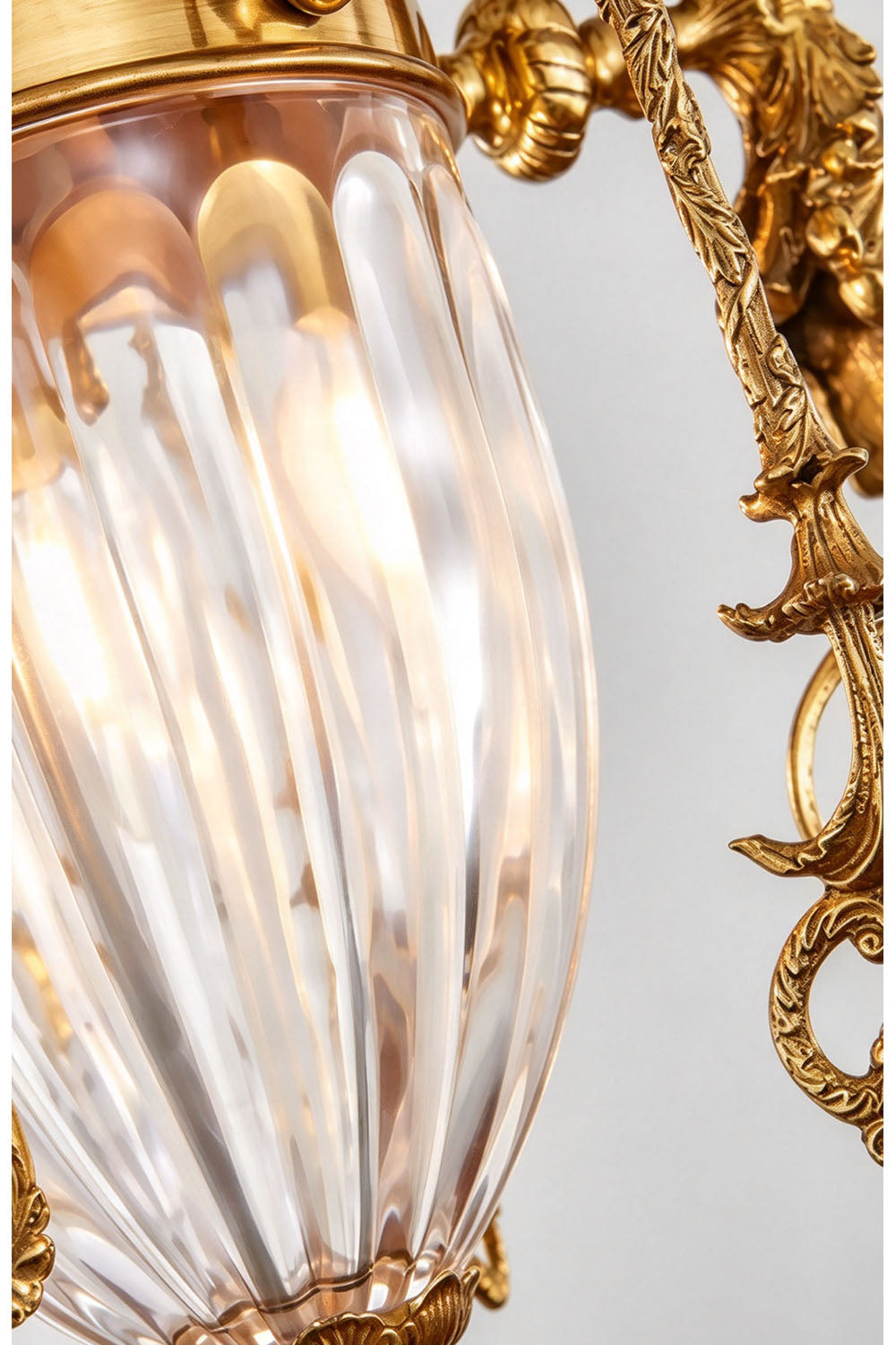 Aveyron Brass Urn Candle Chandelier | Solid Brass and Glass | Close-up detail shot of the central fluted glass urn emitting warm light | Samu Lamp