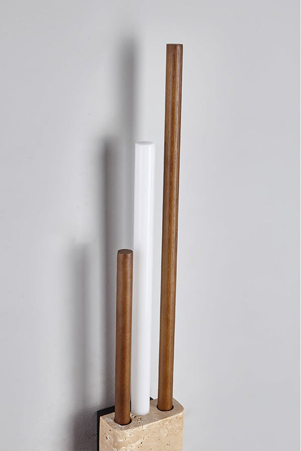Detailed close-up of Axis Terra wall light | Travertine, Metal, Glass | Showing the lit glass tubes and stone texture | Samu Lamp