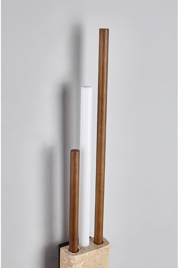 Detailed close-up of Axis Terra wall light | Travertine, Metal, Glass | Showing the lit glass tubes and stone texture | Samu Lamp
