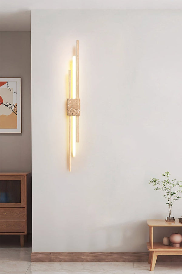 Axis Terra wall sconce in a minimalist living area | Travertine, Metal, Glass | Mounted on a plain white wall | Samu Lamp
