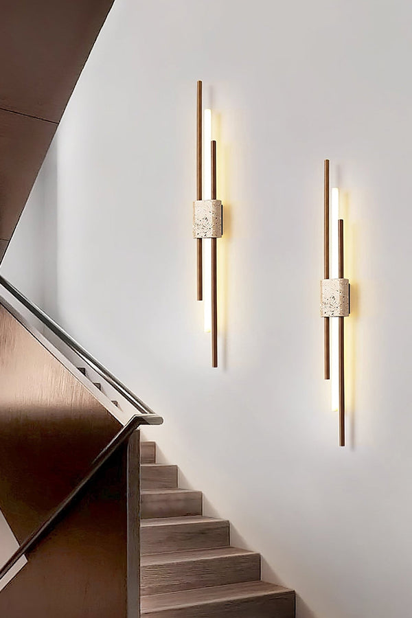 Pair of vertical Axis Terra lights near stairs | Travertine, Metal, Glass | Bright interior lighting on white wall | Samu Lamp