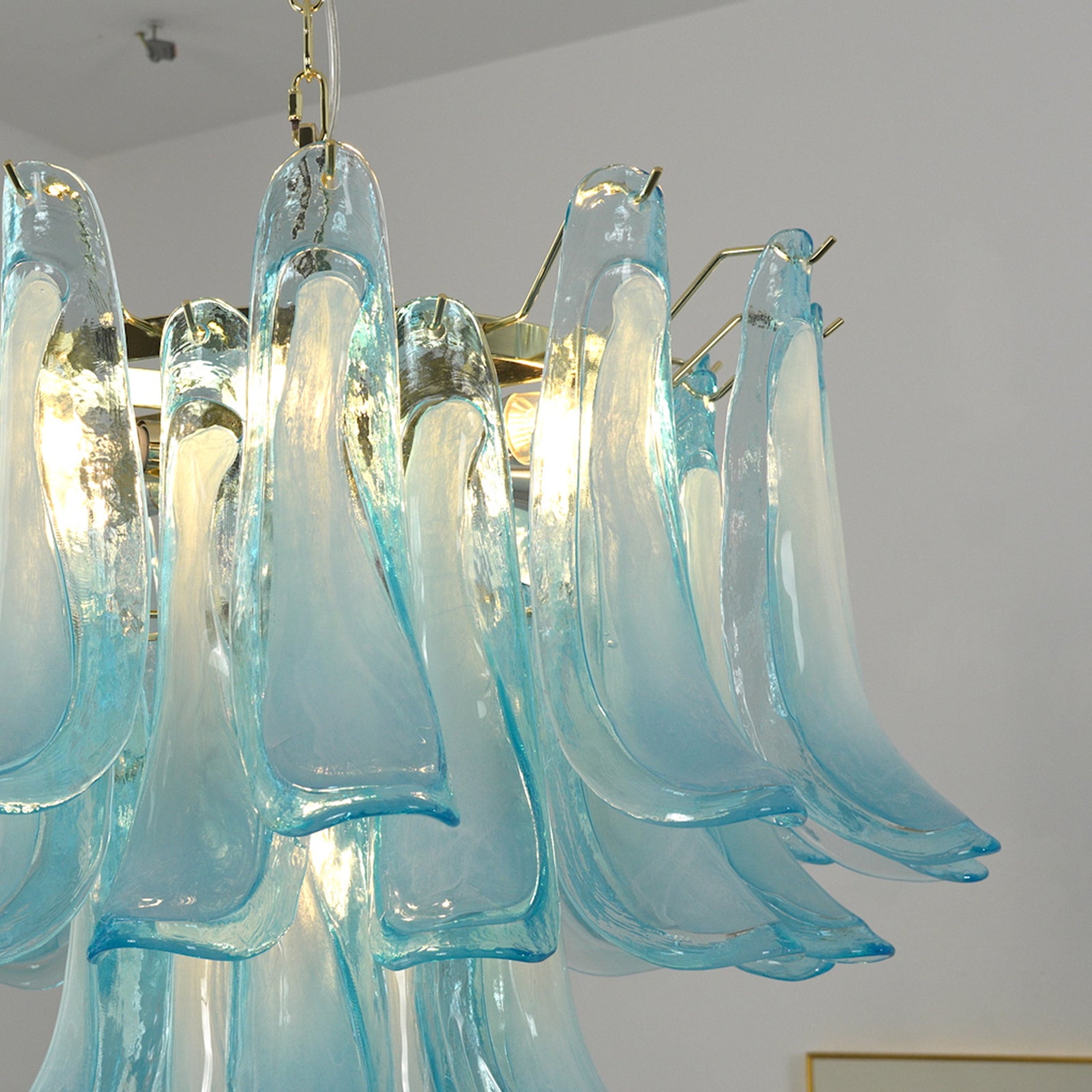 Elegant Azurea petal glass chandelier with gold accents, showcasing a unique, aesthetic design.