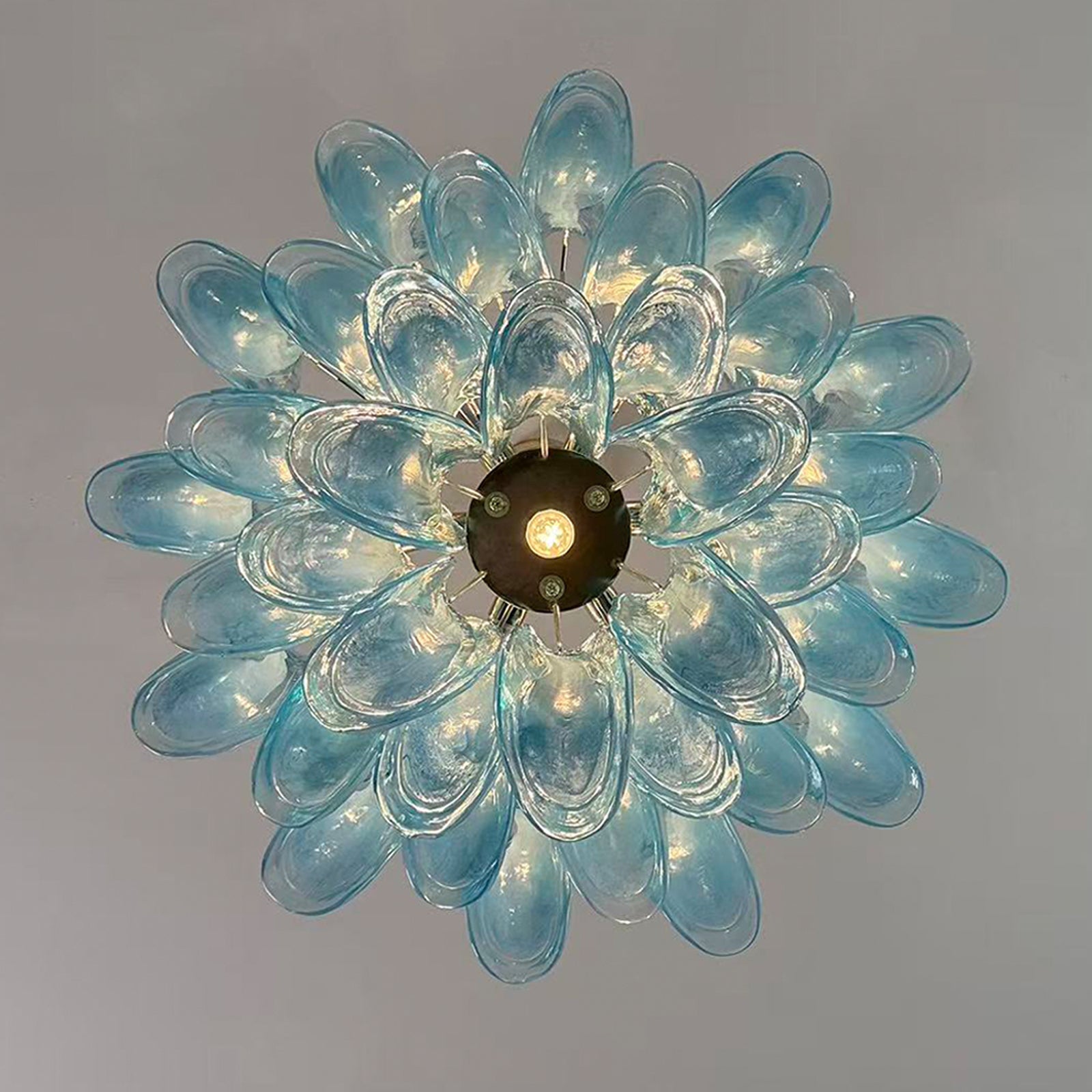 Elegant chandelier with azure petal-shaped glass shades radiating from a central light.