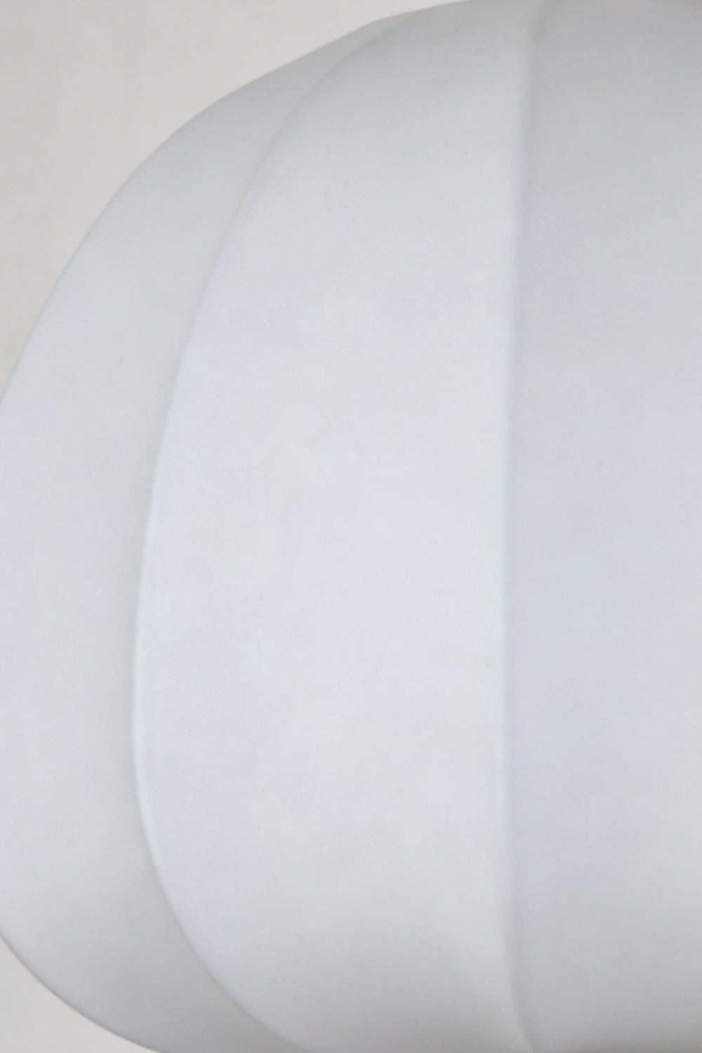 Baird Mid Century Pumpkin Wall Lamp | Metal, Fabric, Wood | Extreme close-up view highlighting the smooth white fabric texture and curved piping of the unlit shade | Detail shot | Samu Lamp