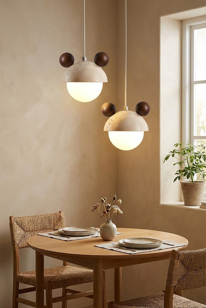 Pair of bear ear travertine pendant lights | Travertine, Metal, Glass | Hanging over a small round wooden dining table | Samu Lamp