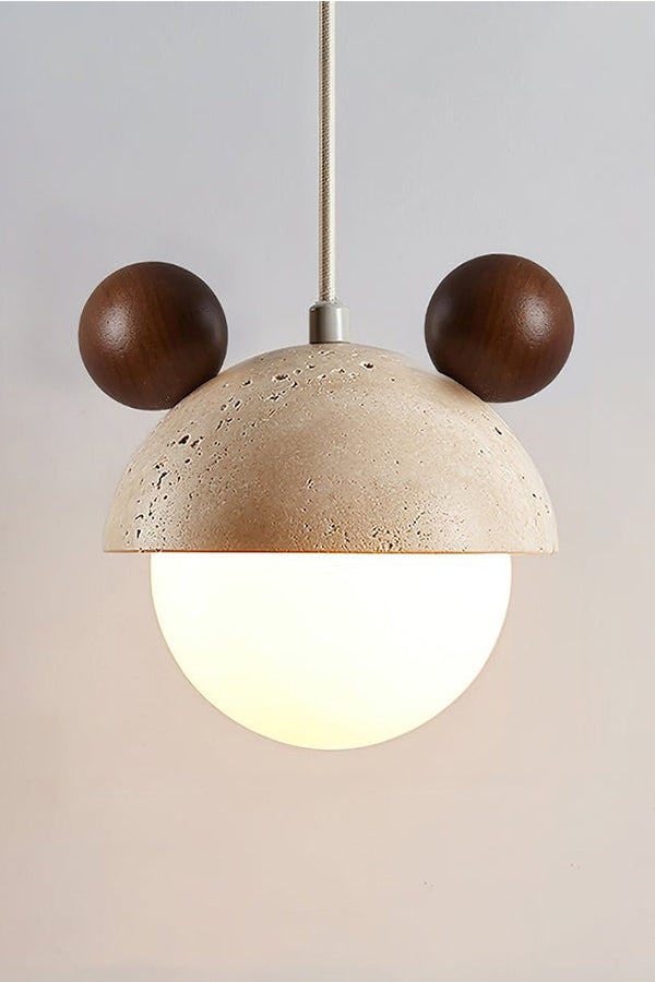 Lit bear ear travertine pendant with dark accents | Travertine, Metal, Glass | Close-up front view showing warm glow | Samu Lamp