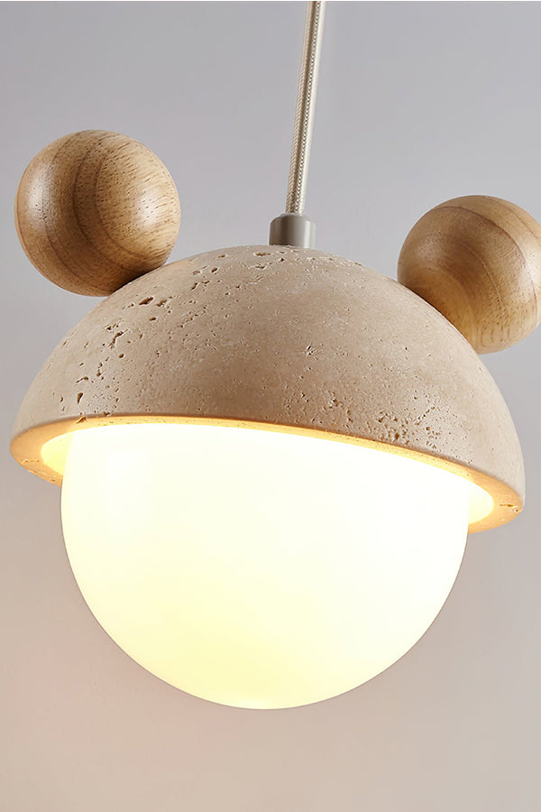 Side perspective of lit bear ear stone pendant | Travertine, Metal, Glass | Showing the warm illumination and textures | Samu Lamp