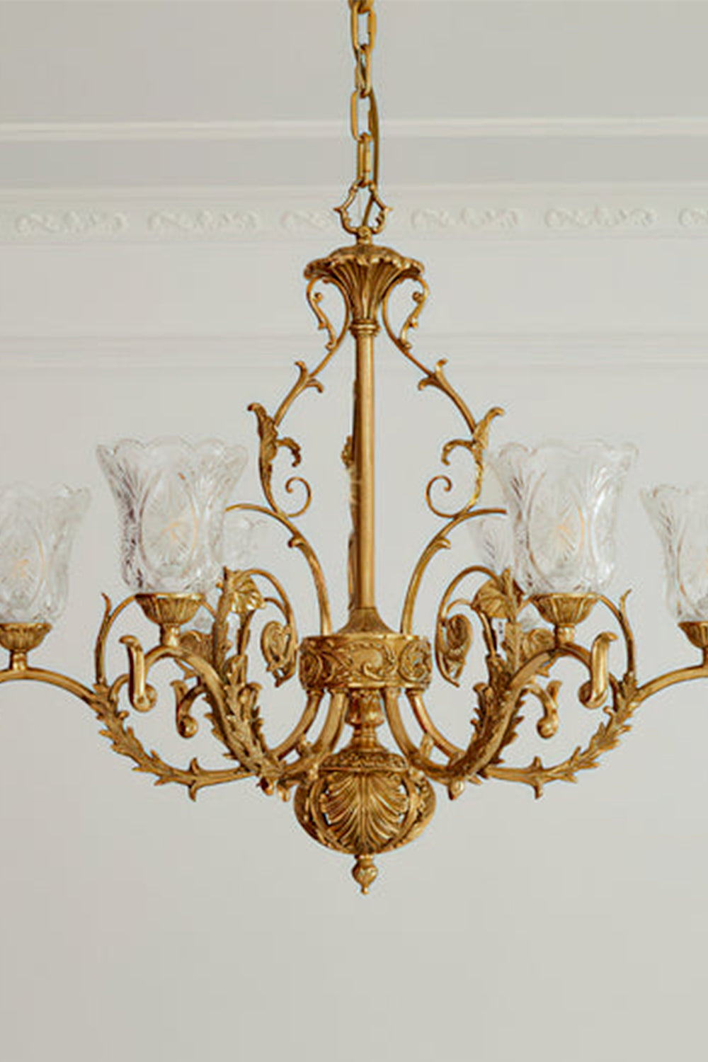 Beatrix Acanthus Leaf Chandelier | Ornate Brass and Frosted Carved Glass | Standard unlit product view hanging from a plain plaster ceiling against a light grey background | Samu Lamp