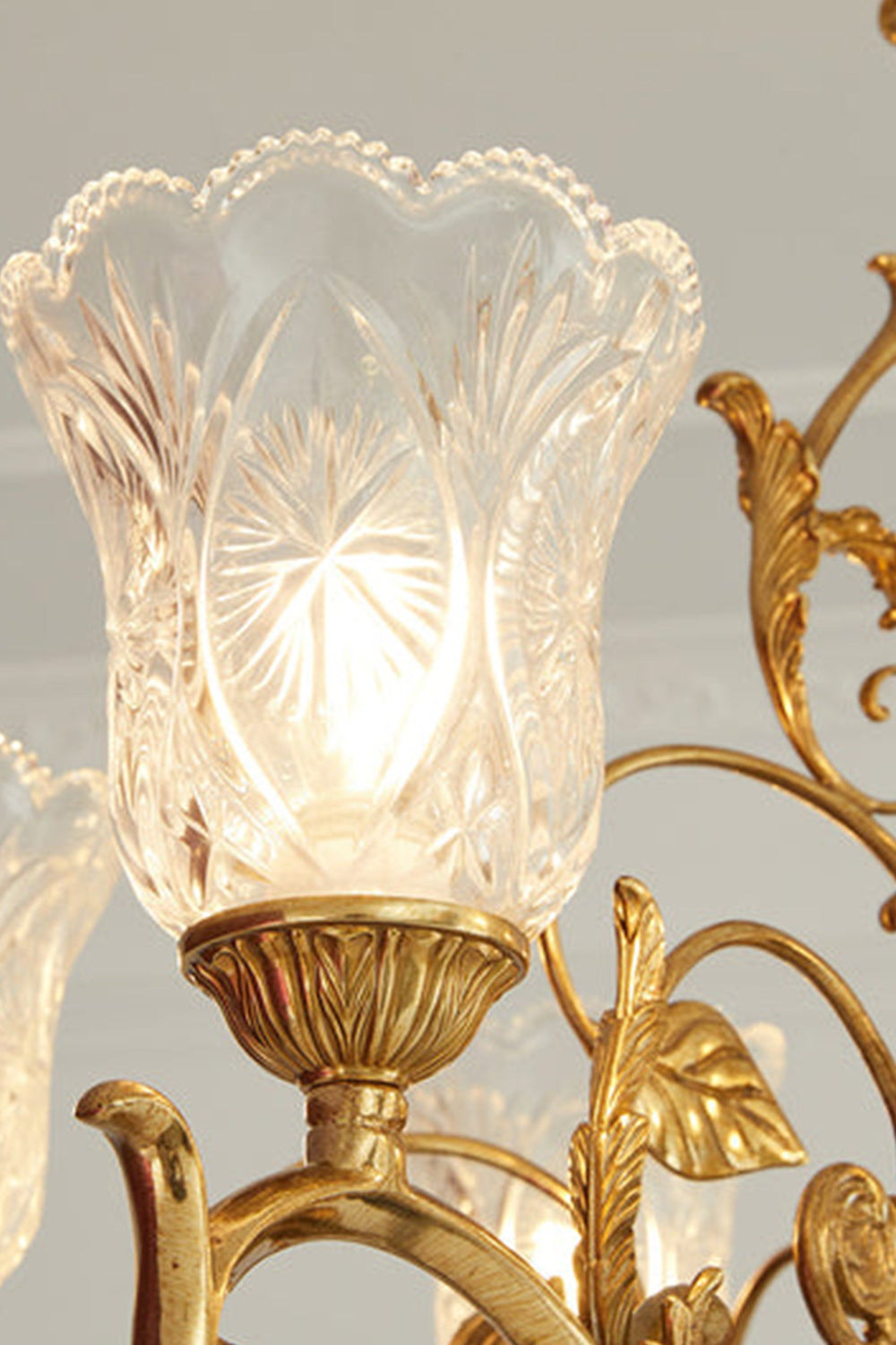 Beatrix Acanthus Leaf Chandelier | Ornate Brass and Frosted Carved Glass | Close-up macro detail of the lit ruffled glass shade showcasing the starburst carvings and gold leaf frame | Samu Lamp