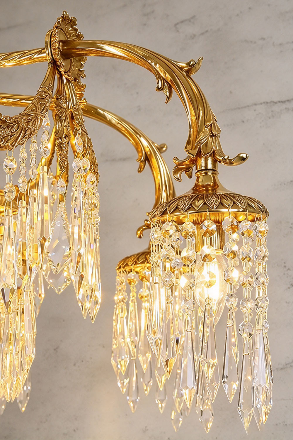 Belcastre Brass Crowned Crystal Cascade Chandelier | Cut Crystal and Brass | Close-up view of carved brass scroll arms and hanging crystal drops | Samu Lamp