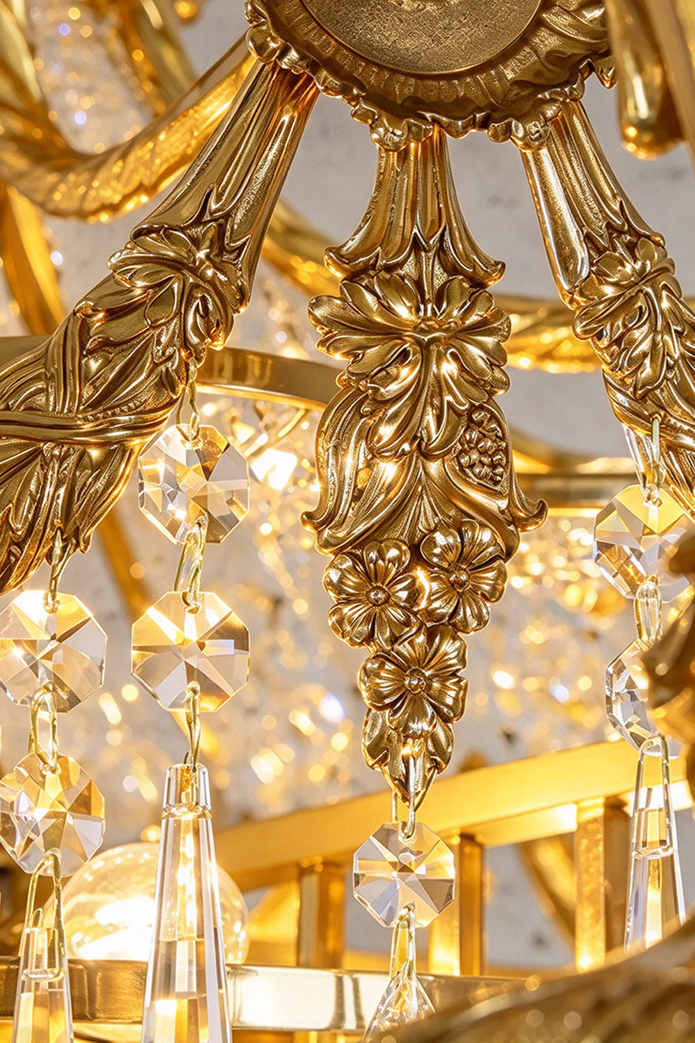 Belcastre Brass Crowned Crystal Cascade Chandelier | Cut Crystal and Brass | Macro close-up of intricate carved brass relief ornaments | Samu Lamp