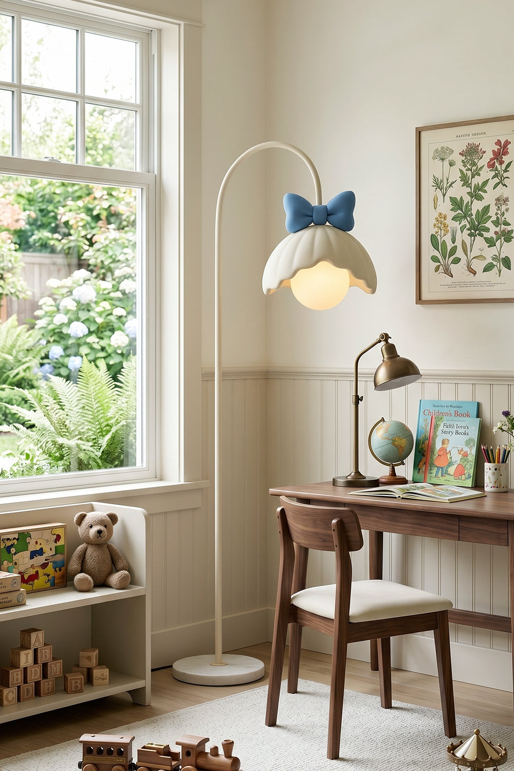 Bella Bow Arched Floor Lamp | Metal, Resin | Blue bow variant illuminating a cozy study corner next to a rustic dark wood desk and toy shelves near a window | Samu Lamp
