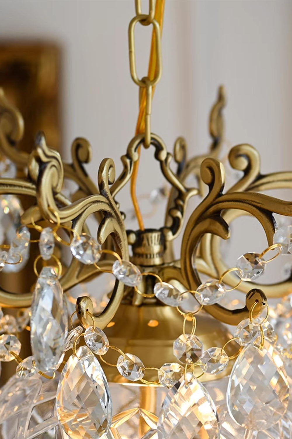 Close-up of the Bertrand Cut Glass Teardrop Pendant Light showcasing its ornate gold frame and sparkling glass details.