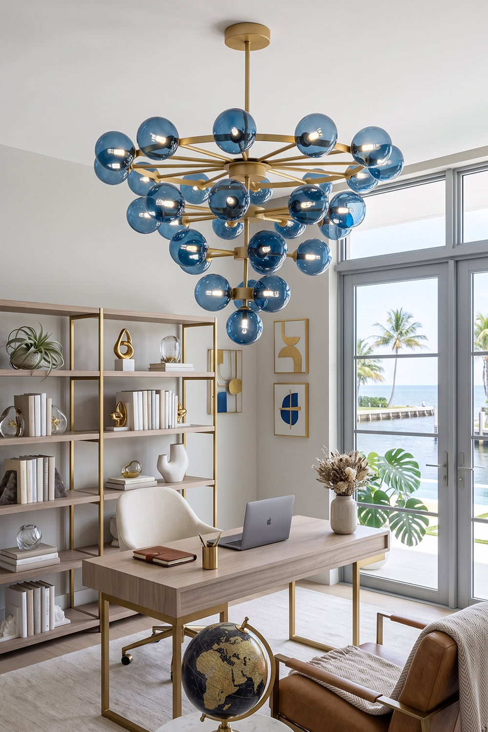 Blue Glass Bubble Globe Tiered Chandelier | Blue Glass and Brass Metal | Suspended over a sleek wooden executive desk in a contemporary home office | Samu Lamp