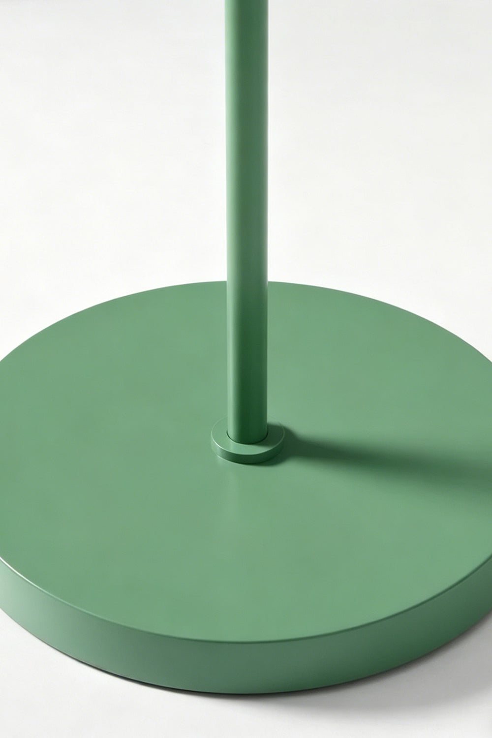 Floor lamp base detail | Metal | Close-up of circular green metal base and stem | Matte finish texture | Samu Lamp