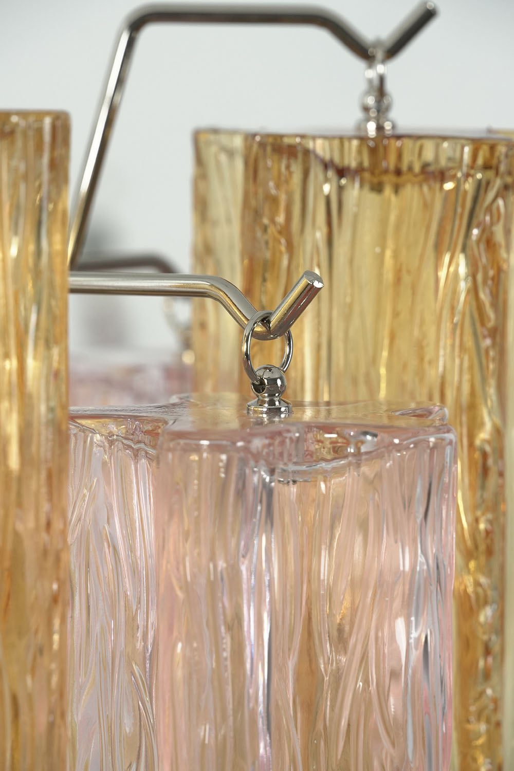 Brevalle Mini Chandelier | Metal and Ribbed Glass | Detailed angled view of metal arm holding glass cylinder | Samu Lamp