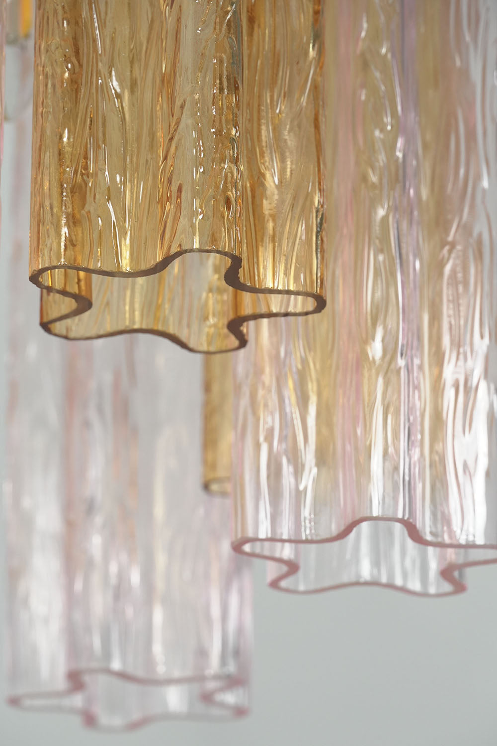 Brevalle Mini Chandelier | Textured Cast Glass | Macro close-up of top curved rim on amber and clear glass | Samu Lamp