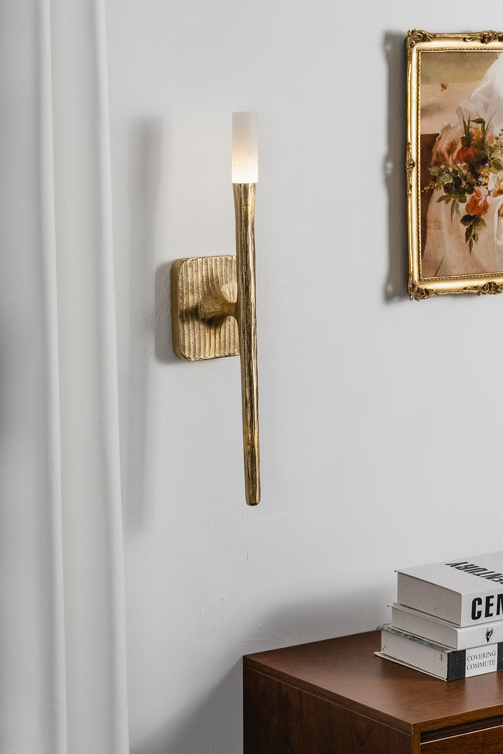 Bryony Torch Alabaster Brass Wall Lamp illuminating a modern interior with elegant design.