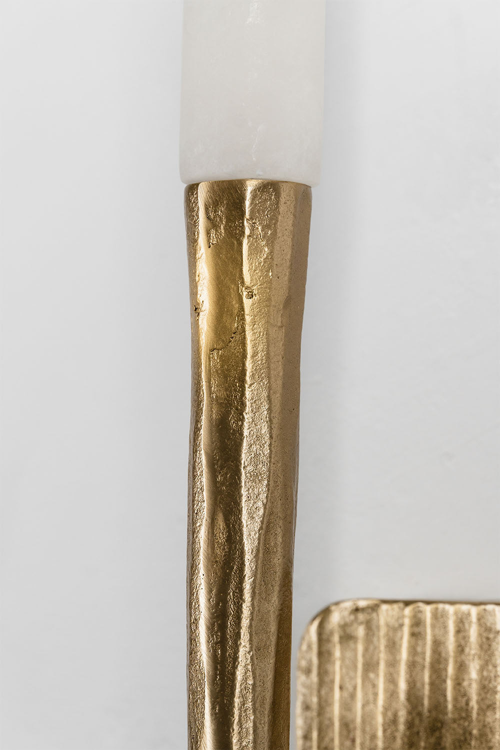 Close-up of the Bryony Torch Alabaster Brass Wall Lamp showcasing its brass detailing.