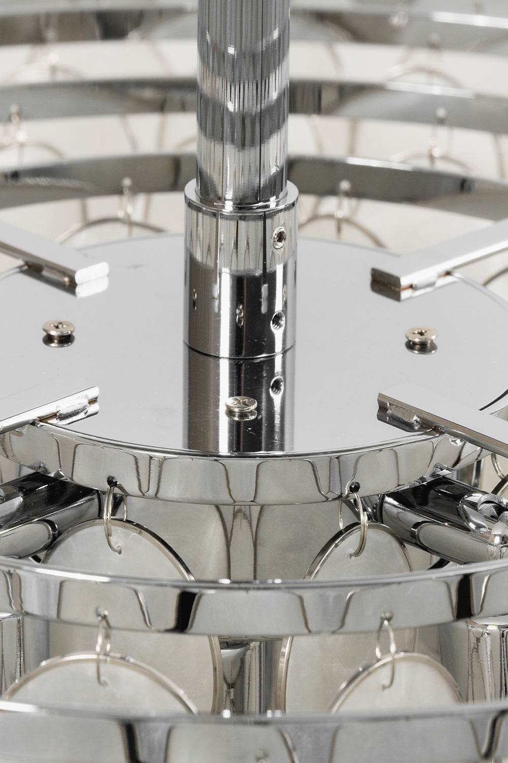 Chrome hardware and tiered frame detail | Iron | Close-up of the polished silver rods and tiers | Samu Lamp