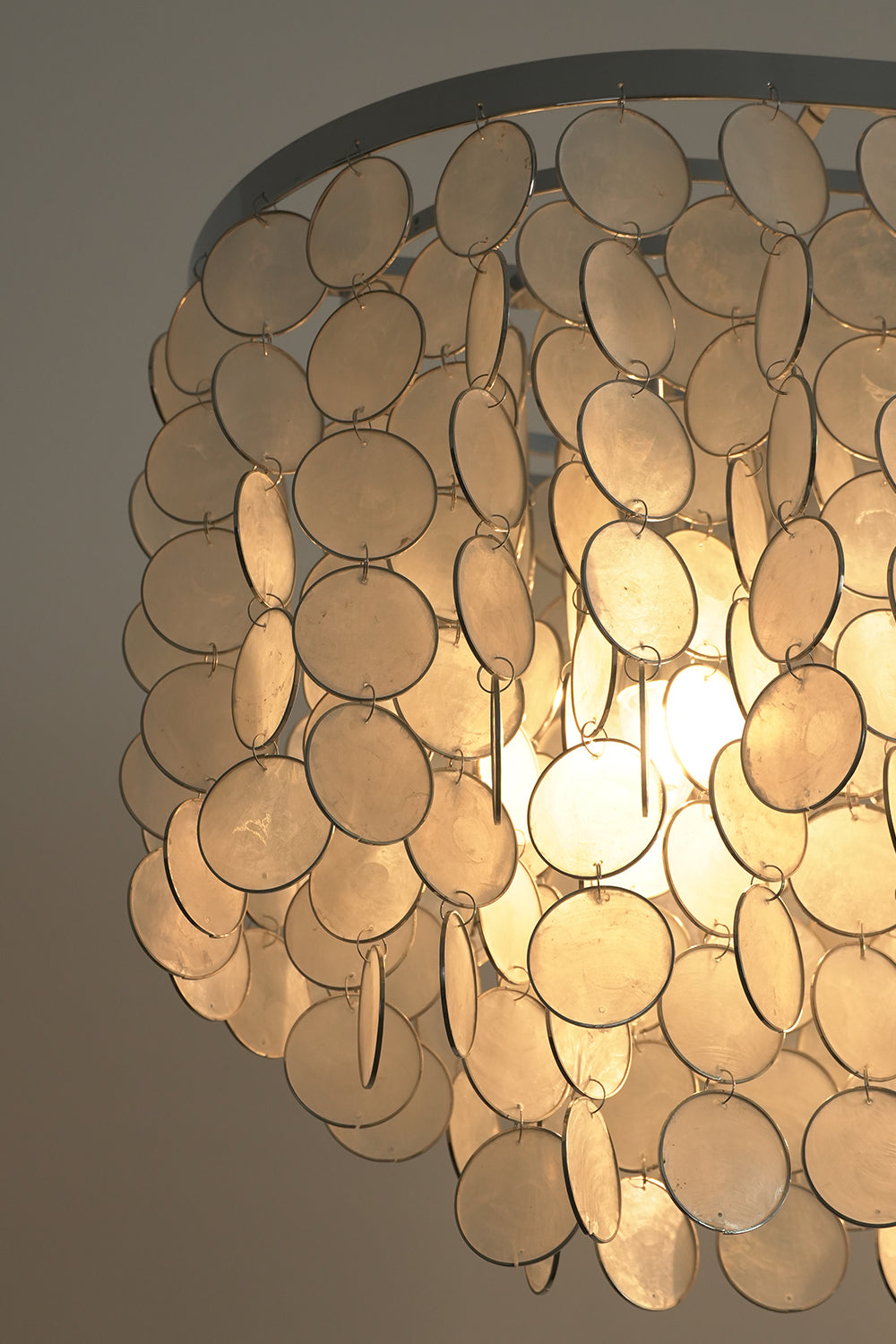 Corner detail of shell chandelier frame | Iron | Shell | Close-up of the chrome hardware and cascading shell panels | Samu Lamp