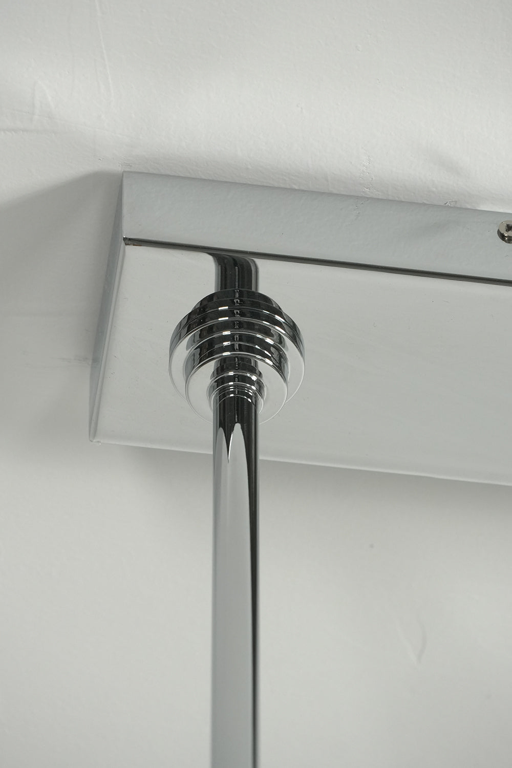 Rectangular chrome ceiling canopy | Iron | Detail shot of the mounting hardware and rods | Samu Lamp