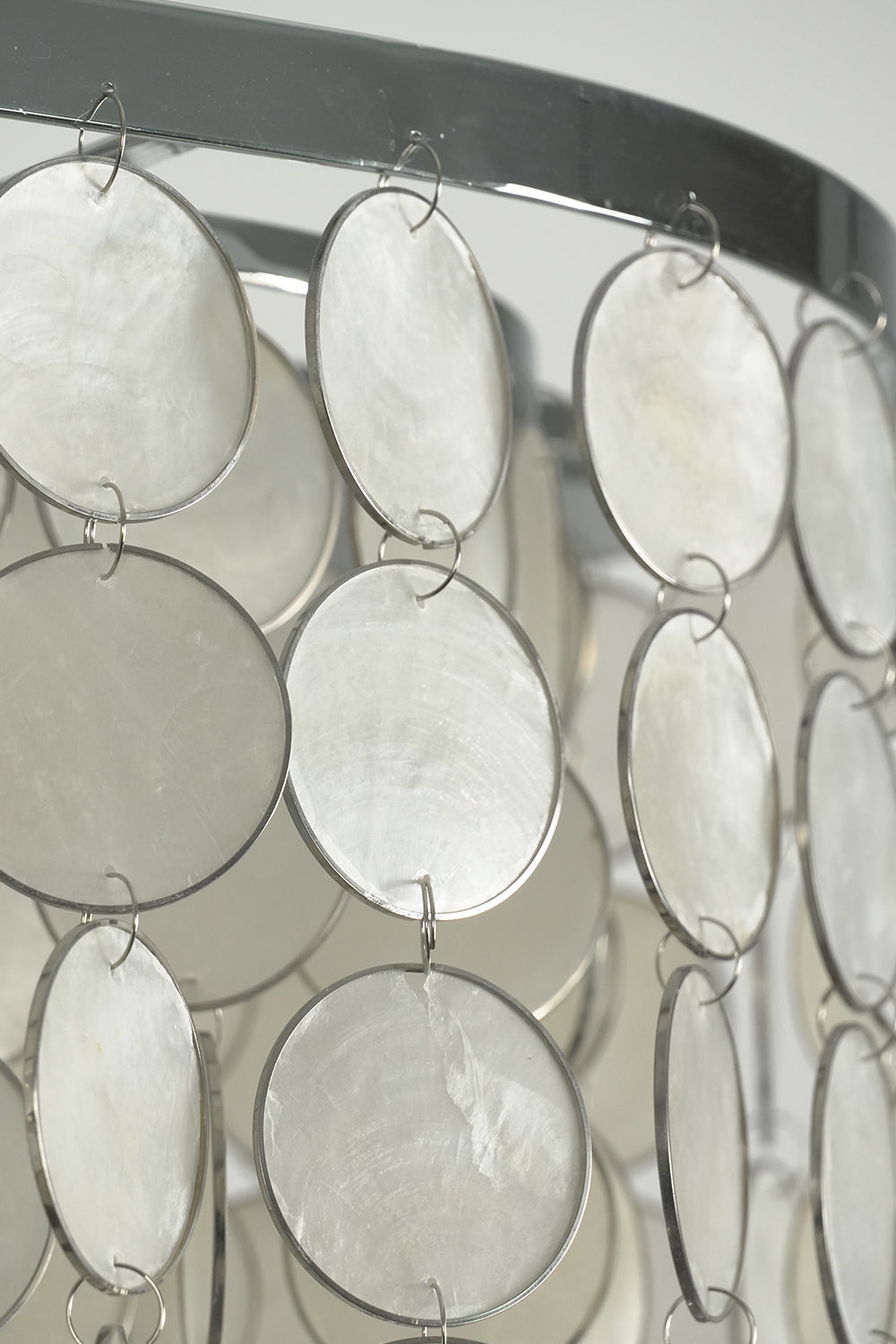 Cascading shell discs on metal frame | Iron | Shell | Side profile showing the texture and layering of the chandelier | Samu Lamp