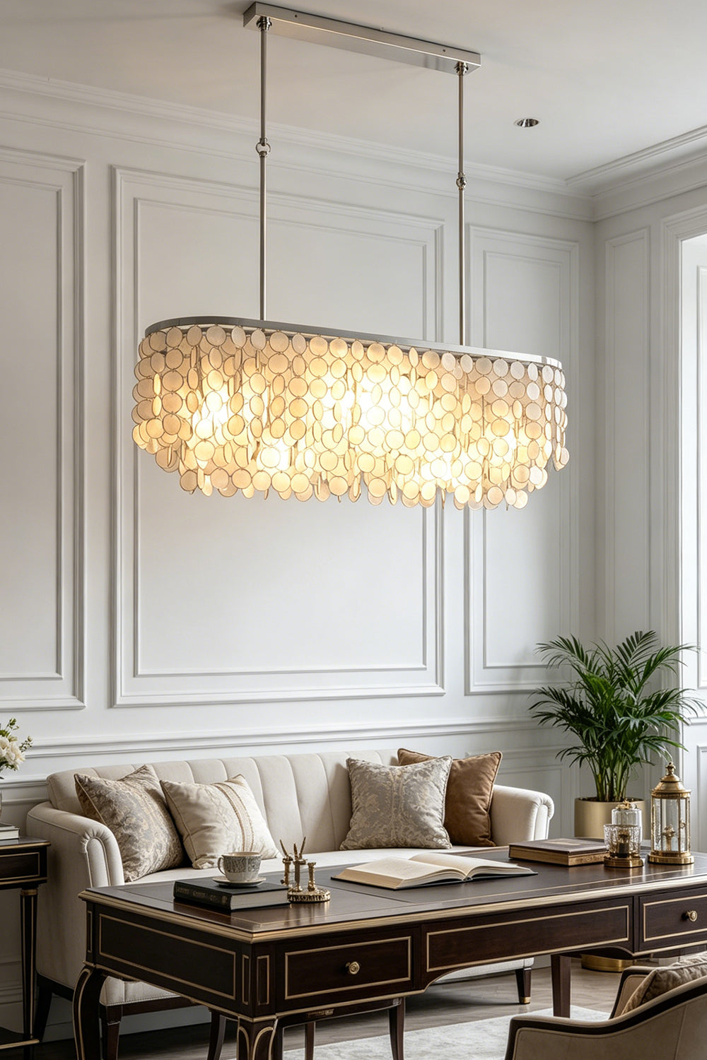 Luxury elongated shell chandelier | Iron | Shell | Hanging in a sophisticated living room over a dark coffee table | Samu Lamp