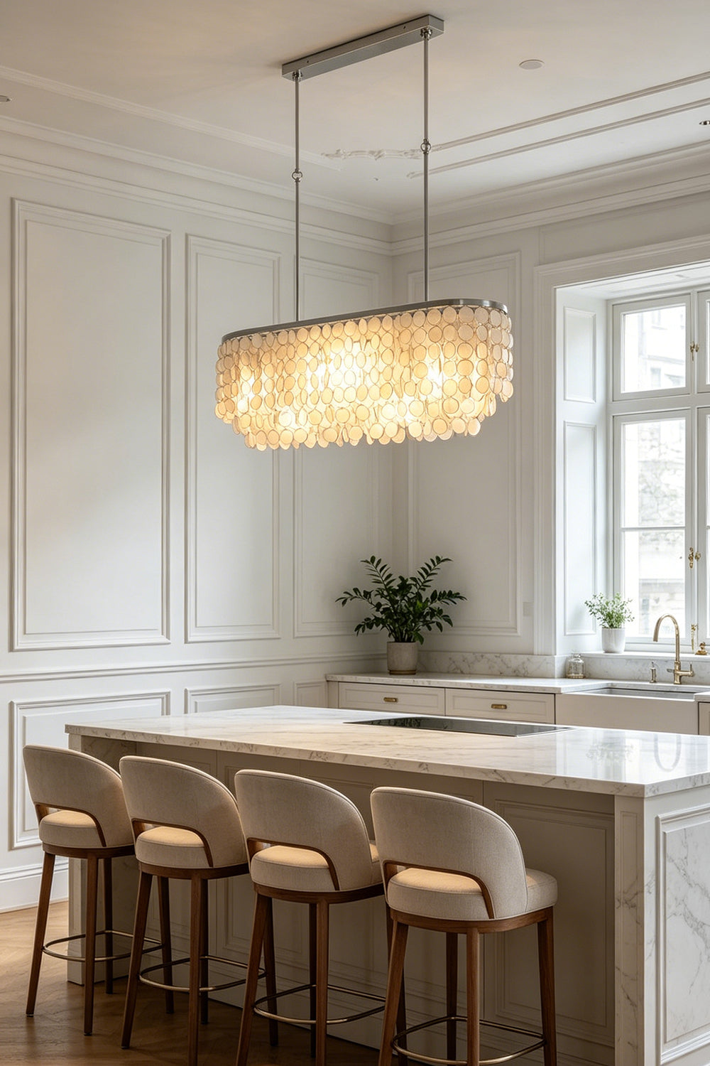 Modern linear shell chandelier | Iron | Shell | Mounted above a marble kitchen island with four high stools | Samu Lamp