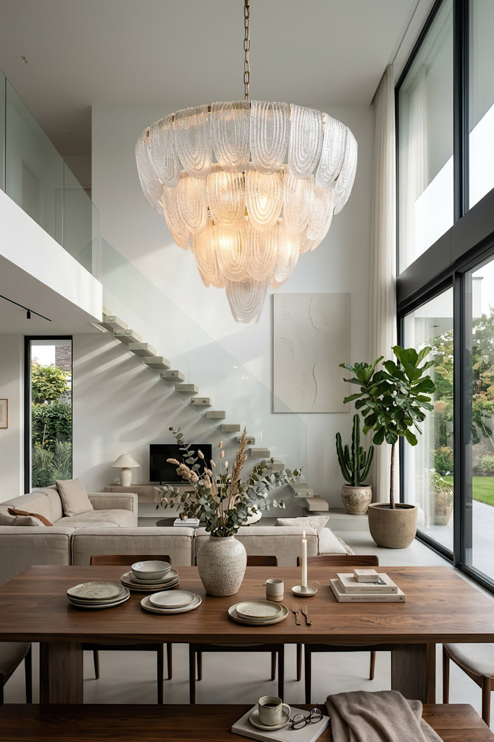 Elegant cascading glass chandelier near staircase | Metal, Glass | High-ceiling living room interior with modern decor | Samu Lamp