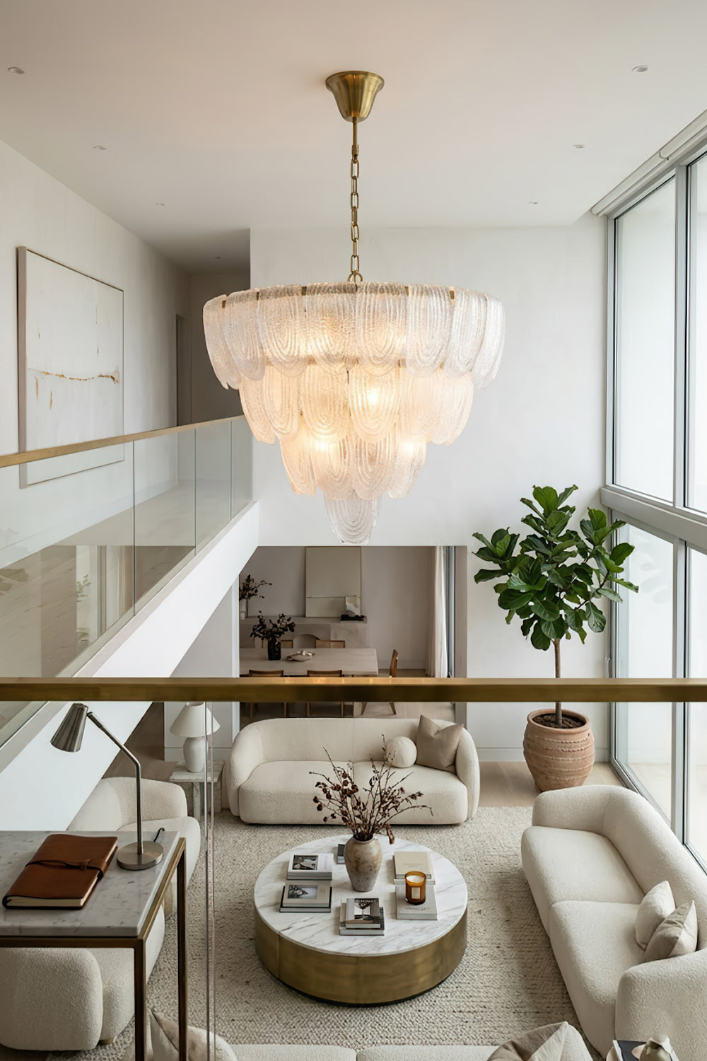 Modern cascading glass chandelier view from loft | Metal, Glass | Looking down into a bright living room with circular coffee table | Samu Lamp