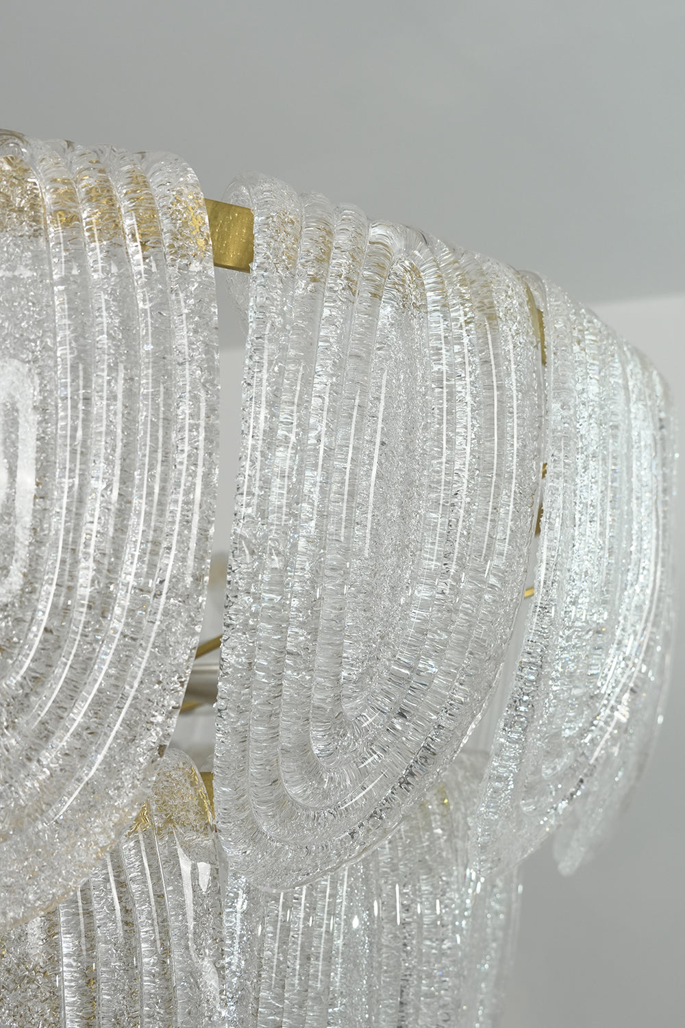 Detailed close-up of textured glass petals | Glass | Showing the intricate organic pattern of the cascading chandelier | Samu Lamp