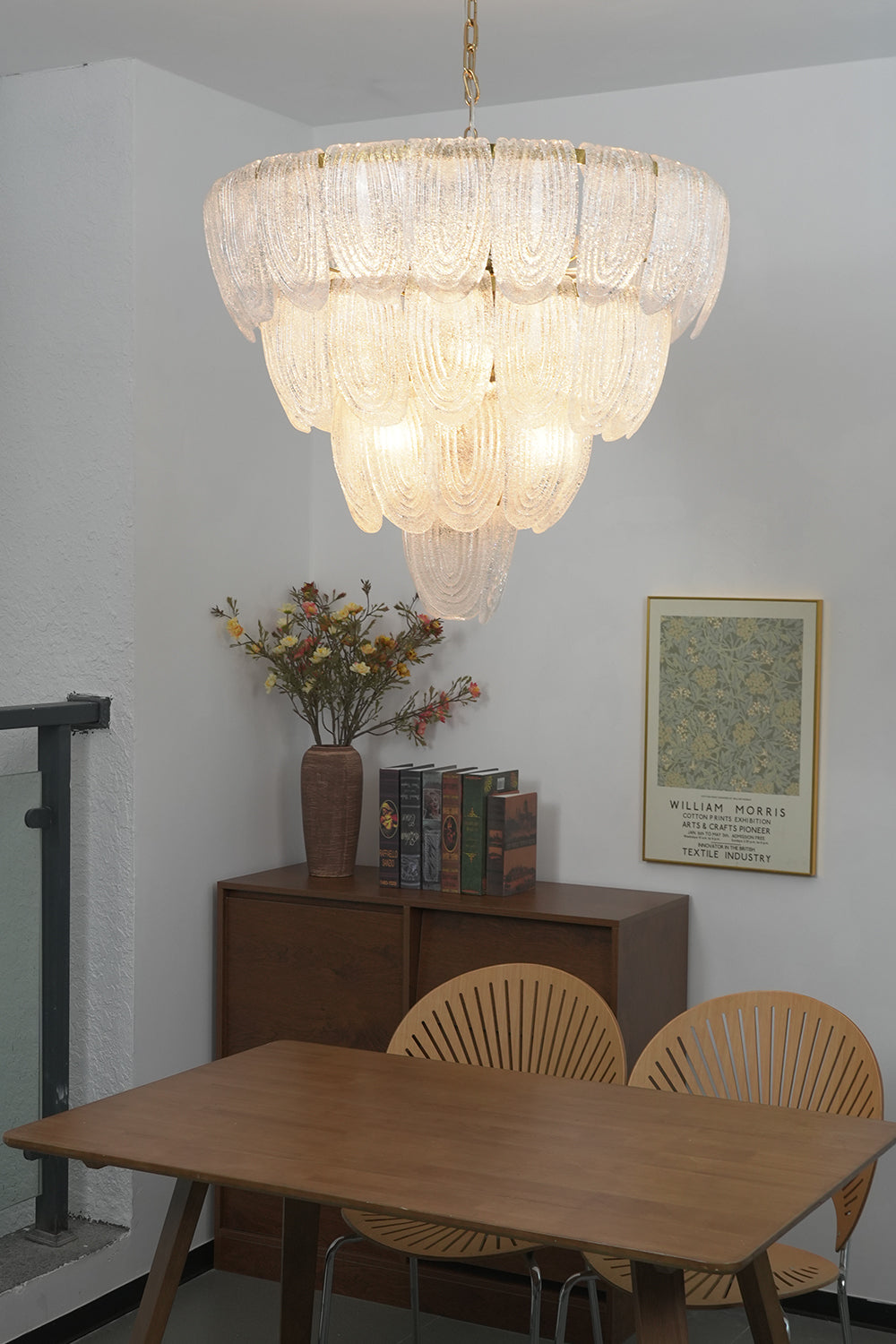 Large cascading glass chandelier over dining table | Metal, Glass | Centered in a traditional dining room with wooden chairs | Samu Lamp