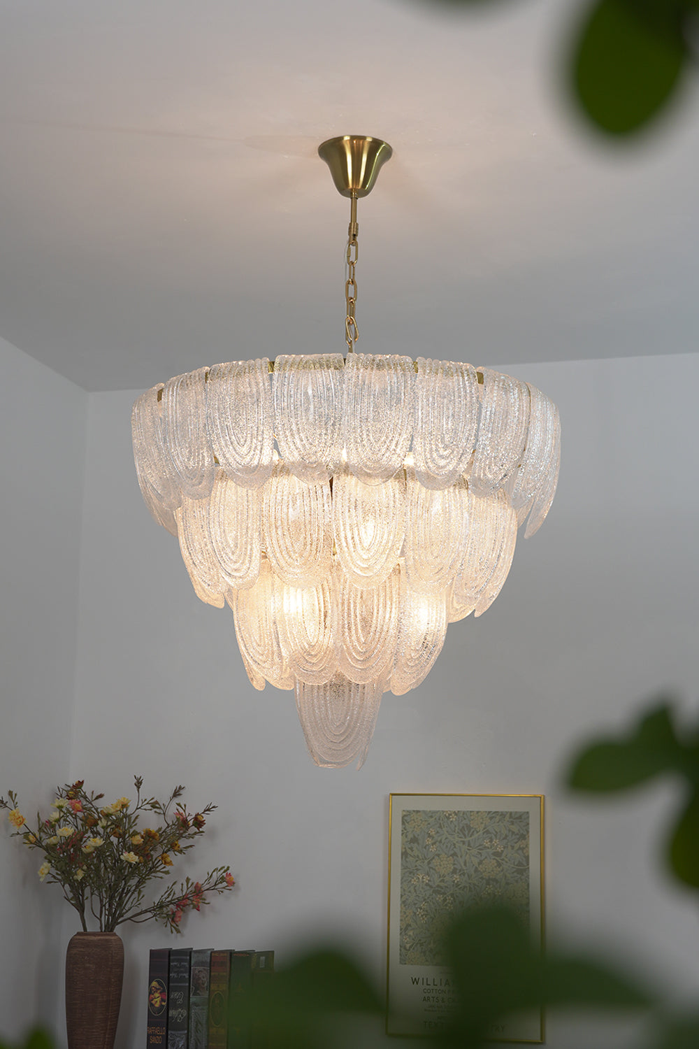 Cascading glass petal chandelier in modern living room | Metal, Glass | View from a distance showing high ceilings and natural light | Samu Lamp
