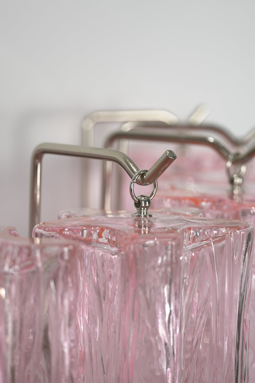Cascading Prism Pink Glass Wall Light | Glass, Metal | Detailed shot of the metal hooks and frame supporting the glass prisms | Detail shot | Samu Lamp Cascading Prism