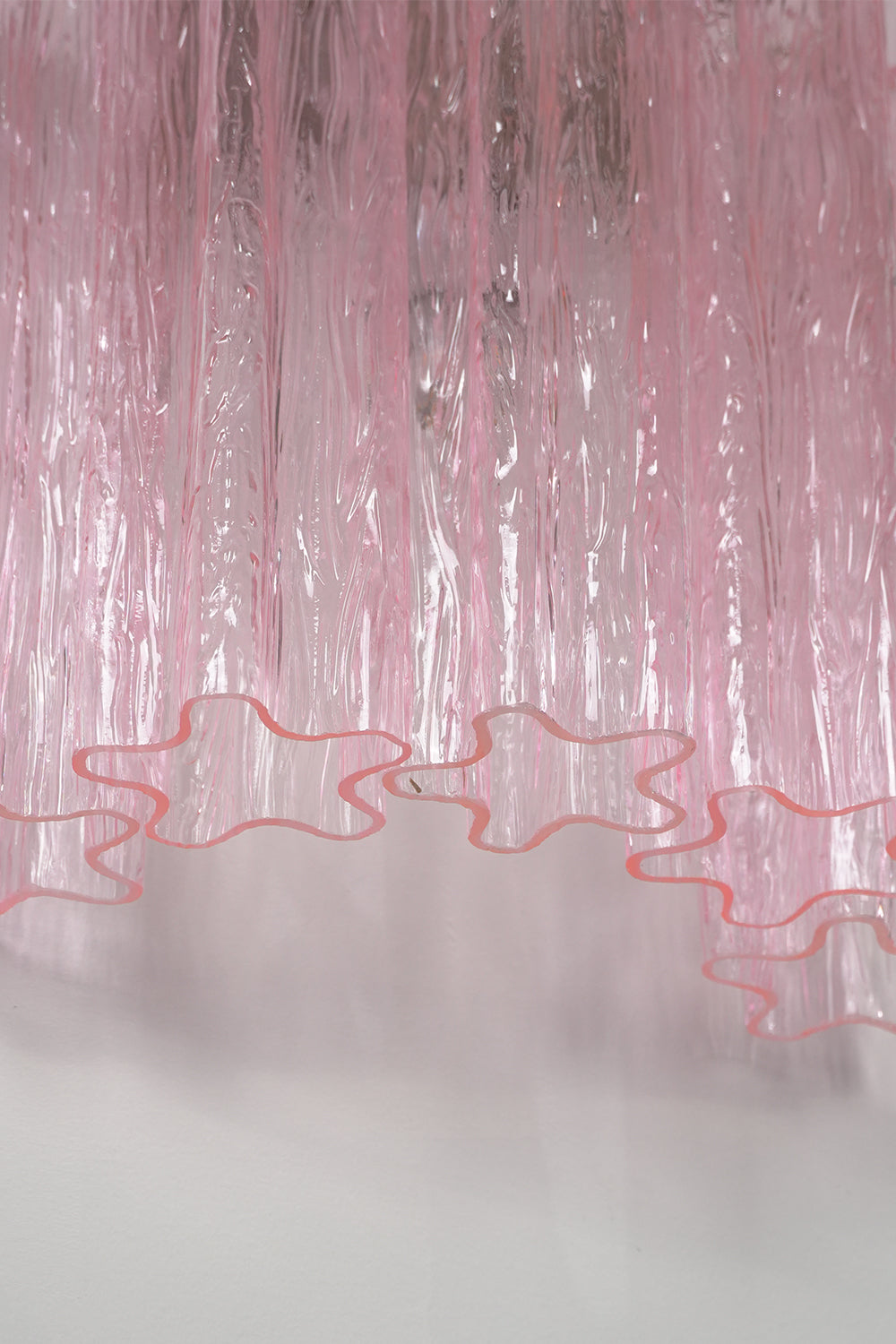 Cascading Prism Pink Glass Wall Light | Glass, Metal | Macro view of the delicate wavy bottom edges of the pink glass elements | Detail shot | Samu Lamp Cascading Prism